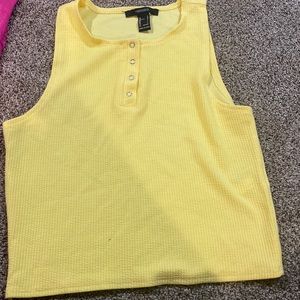 a yellow crop-top no sleeves shirt